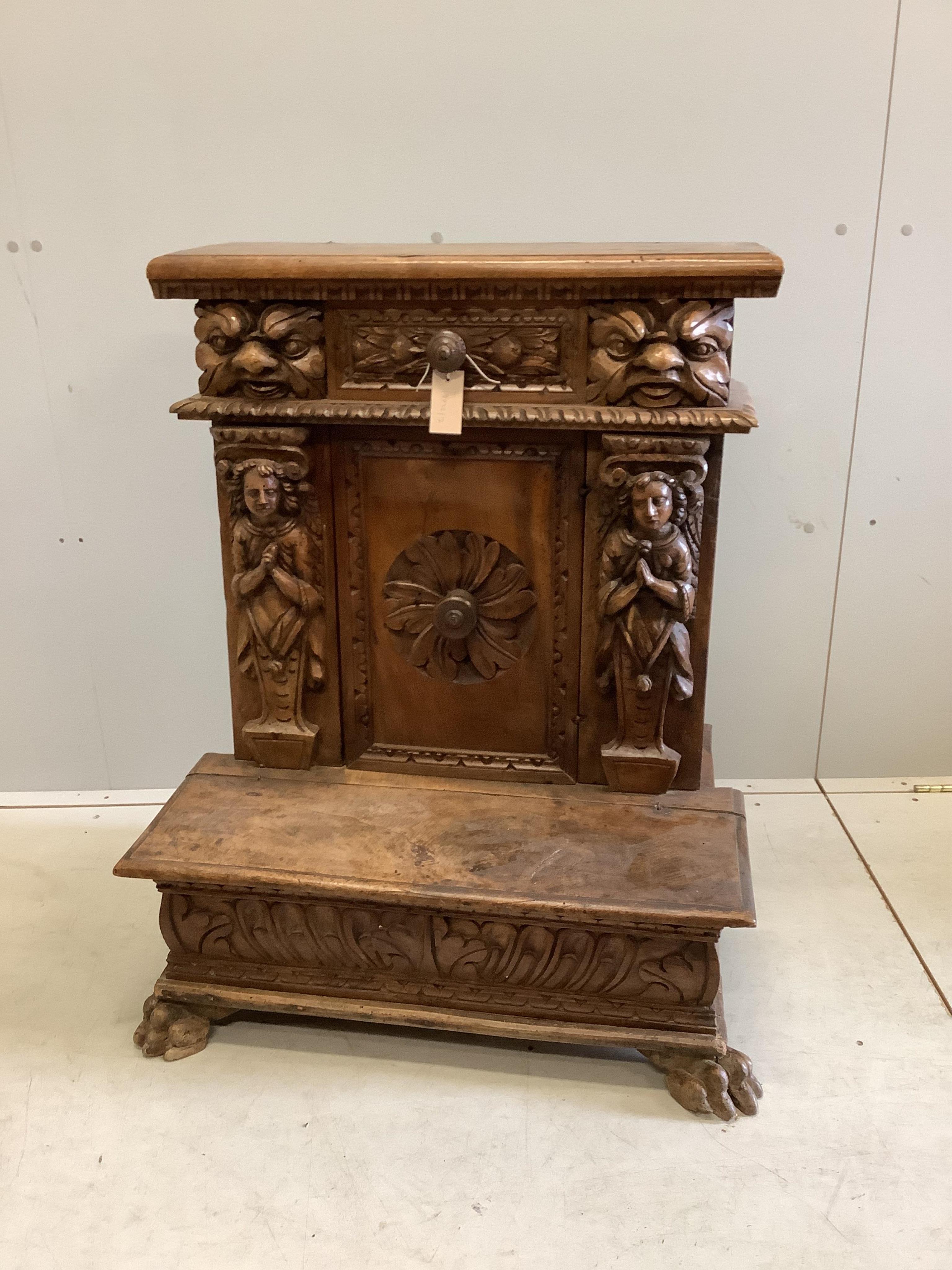 An 18th century style Continental carved walnut prie dieu cabinet, width 72cm, depth 49cm, height 90cm. Condition - poor to fair